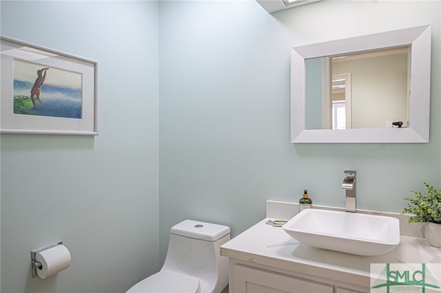 bathroom featuring vanity and toilet