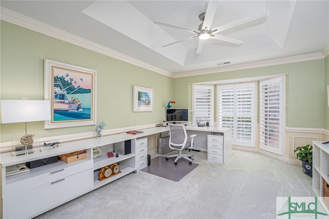 carpeted office space with crown molding, a raised ceiling, and ceiling fan