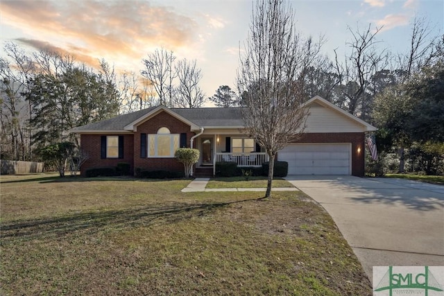 ranch-style home with a garage, a yard, and covered porch