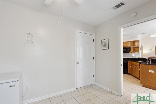 interior space with ceiling fan and sink