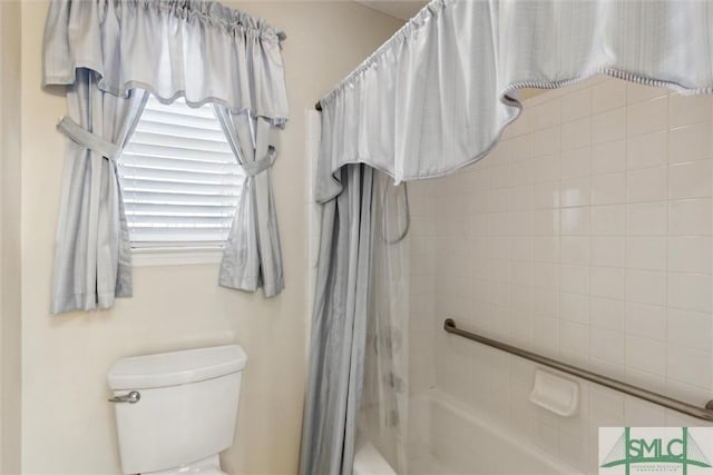 bathroom with shower / bath combo and toilet