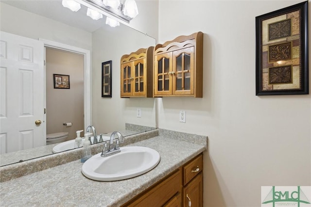 bathroom featuring vanity and toilet