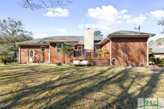 back of house featuring a wooden deck and a yard