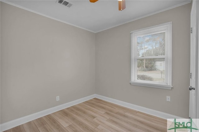 unfurnished room featuring crown molding and light hardwood / wood-style floors