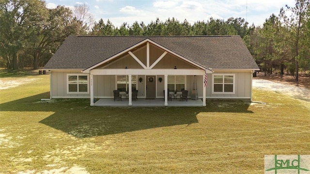 rear view of property with a lawn and a patio