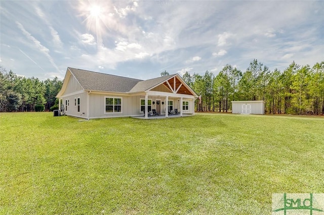 back of property with a storage shed, a patio area, a lawn, and central air condition unit