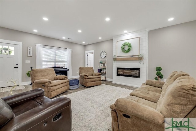 living room featuring hardwood / wood-style flooring and a fireplace