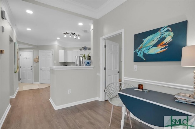 interior space featuring hardwood / wood-style floors and crown molding