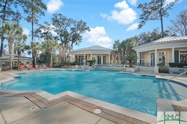 view of swimming pool featuring a patio and pool water feature