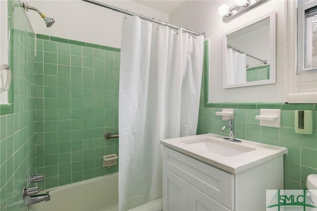 bathroom with vanity, tile walls, and shower / bath combination with curtain