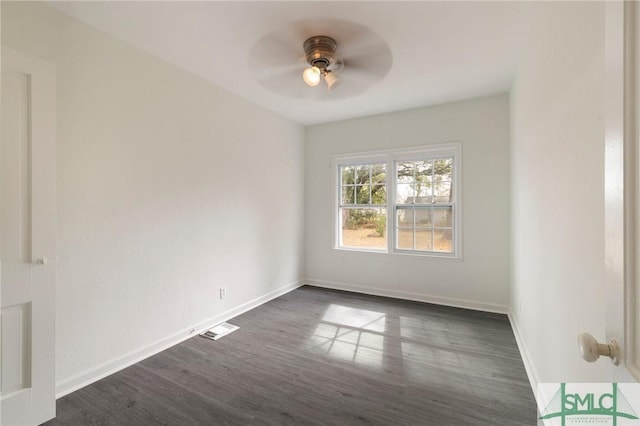 empty room with dark hardwood / wood-style flooring and ceiling fan