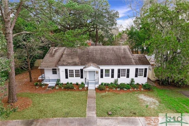 cape cod home with a front yard