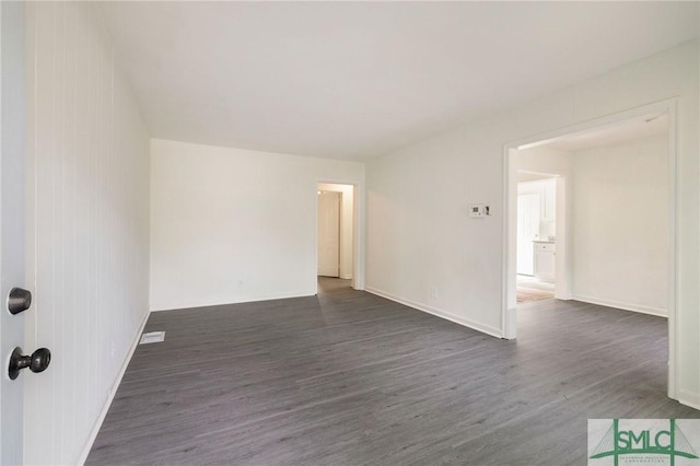 spare room featuring dark hardwood / wood-style flooring