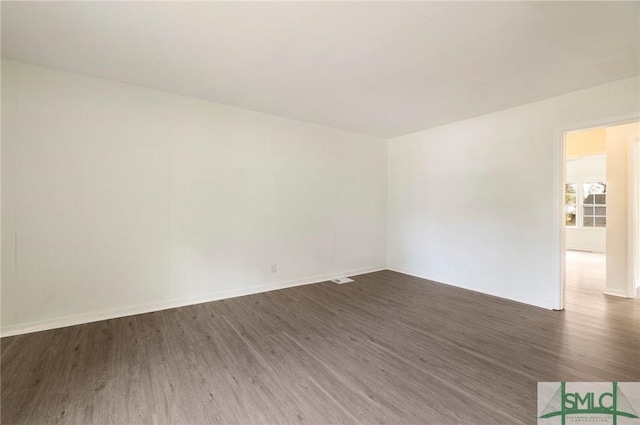 spare room featuring dark hardwood / wood-style floors