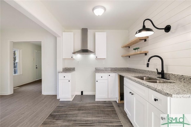 kitchen with white cabinetry, sink, dark hardwood / wood-style flooring, and wall chimney exhaust hood