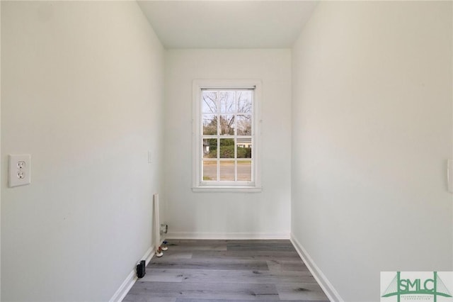 laundry area with hardwood / wood-style flooring