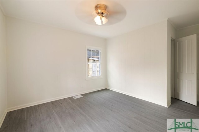 unfurnished room featuring ceiling fan and dark hardwood / wood-style flooring