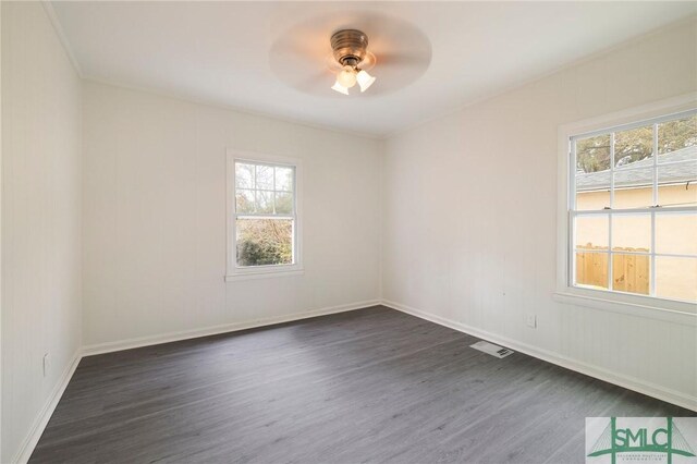 spare room with ceiling fan and dark hardwood / wood-style flooring