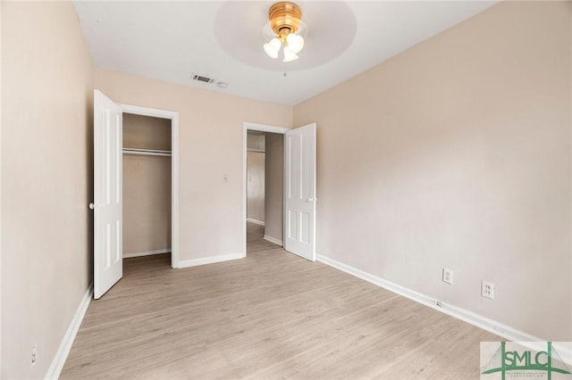 unfurnished bedroom featuring light hardwood / wood-style flooring, a closet, and ceiling fan