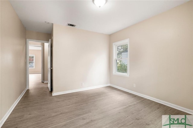 spare room with wood-type flooring