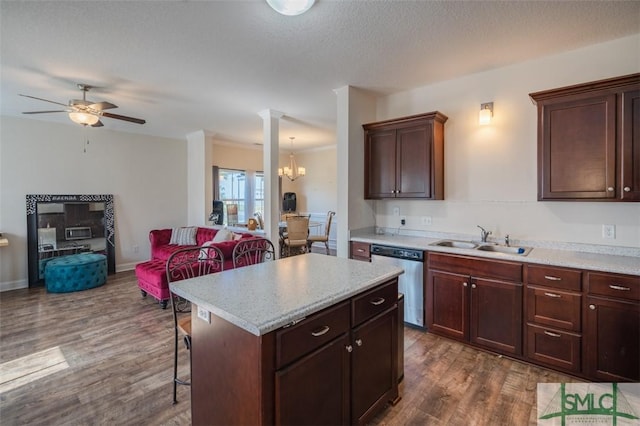 kitchen with a kitchen island, dishwasher, sink, a kitchen bar, and dark hardwood / wood-style flooring