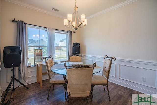 dining space featuring ornamental molding, dark wood-type flooring, and a notable chandelier