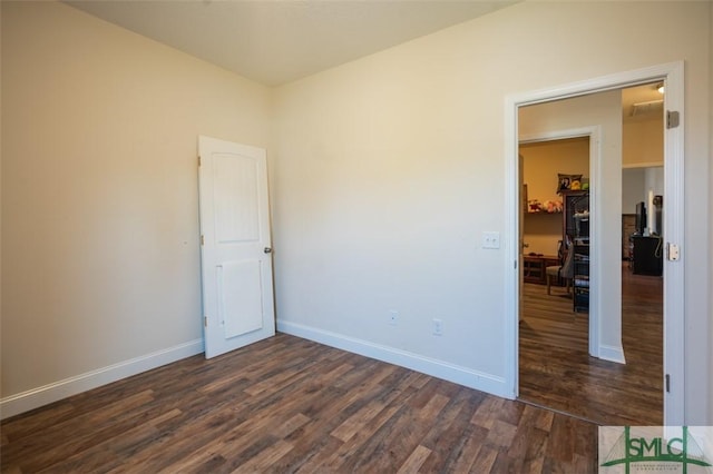 empty room with dark wood-type flooring