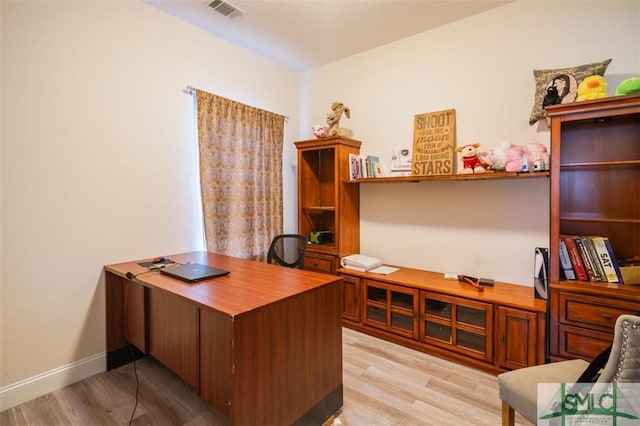 office space with light hardwood / wood-style flooring