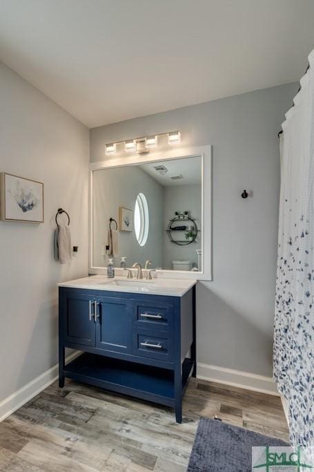 bathroom featuring vanity and hardwood / wood-style flooring