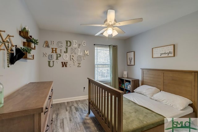 bedroom with hardwood / wood-style floors and ceiling fan