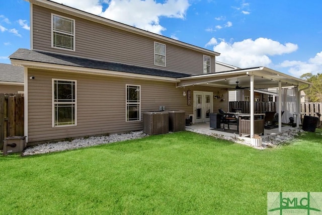 rear view of house with a lawn, central AC unit, ceiling fan, and a patio area