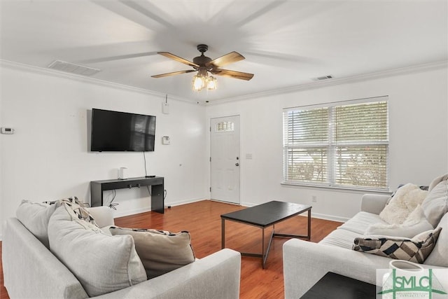 living room featuring hardwood / wood-style flooring, ornamental molding, and ceiling fan