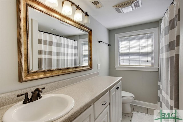 bathroom with vanity, tile patterned flooring, plenty of natural light, and toilet