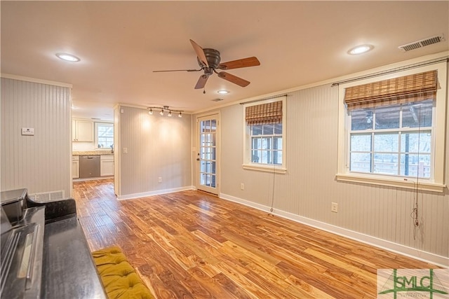 unfurnished living room with ceiling fan and light hardwood / wood-style flooring