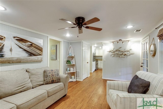 living room with ceiling fan and light hardwood / wood-style floors