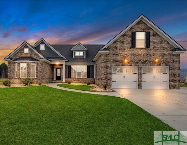 view of front of property with a garage and a lawn