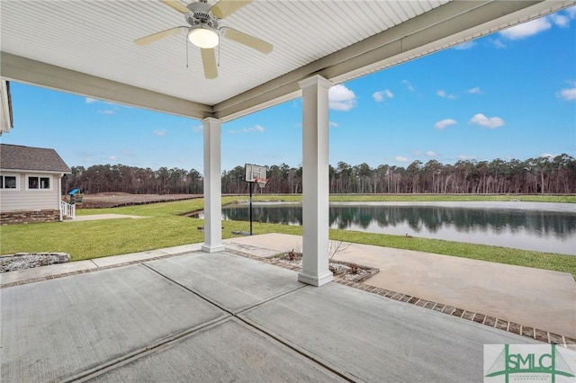 view of patio with a water view and ceiling fan