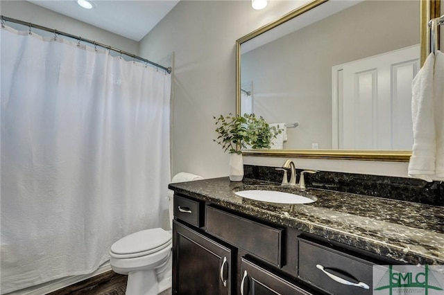 bathroom featuring hardwood / wood-style flooring, vanity, and toilet