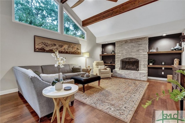 living room with dark hardwood / wood-style flooring, a stone fireplace, high vaulted ceiling, and beamed ceiling