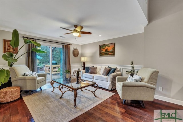 living room featuring crown molding, dark wood-type flooring, and ceiling fan