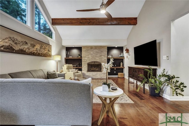 living room with a stone fireplace, hardwood / wood-style floors, high vaulted ceiling, beamed ceiling, and ceiling fan