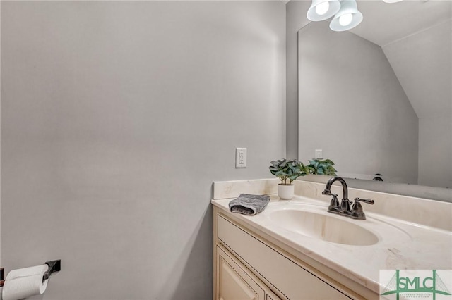 bathroom featuring vanity and vaulted ceiling