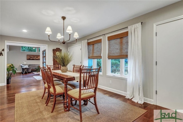 dining space featuring a notable chandelier and dark hardwood / wood-style floors