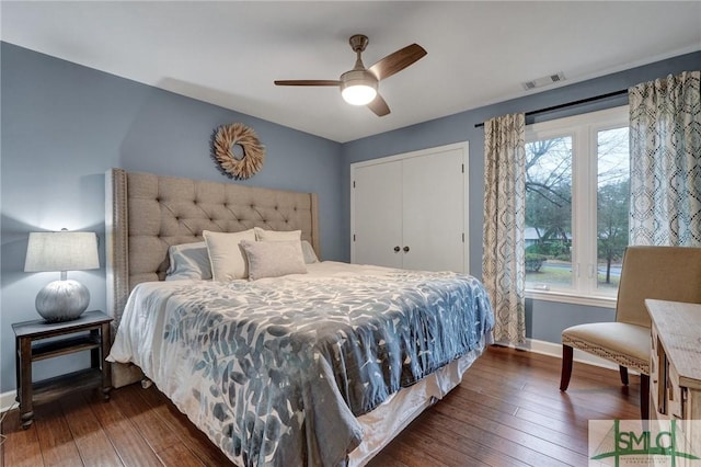 bedroom with a closet, dark hardwood / wood-style floors, and ceiling fan