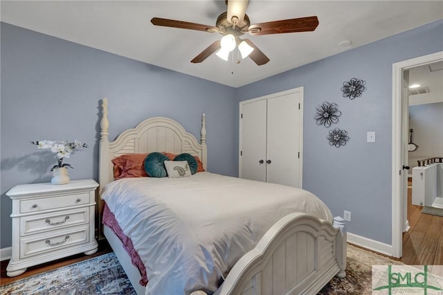 bedroom featuring ceiling fan, wood-type flooring, and a closet