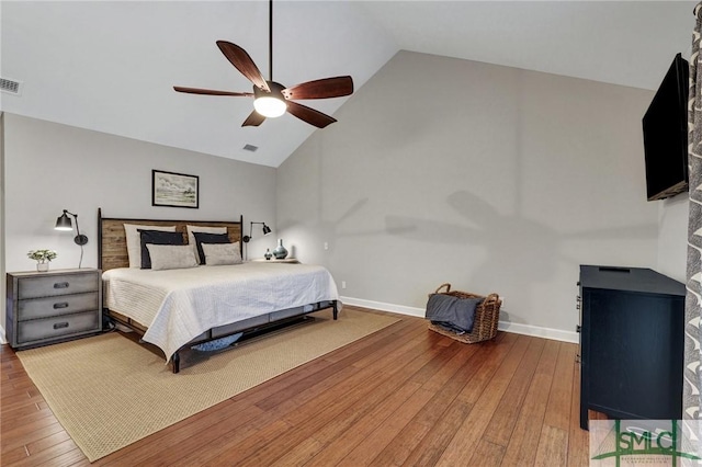 bedroom with ceiling fan, high vaulted ceiling, and hardwood / wood-style floors