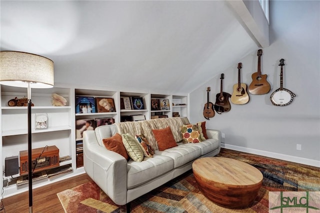 living room with wood-type flooring, vaulted ceiling, and built in shelves