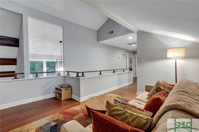 living room with hardwood / wood-style flooring and vaulted ceiling