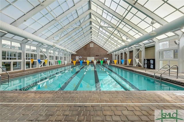 view of swimming pool with glass enclosure