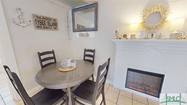 403 13th St, Tybee Island, GA 31328 - dining area featuring a fireplace and light tile patterned flooring
